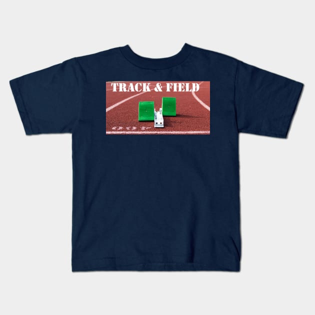 Track and field written above green starting blocks on a red track Kids T-Shirt by Woodys Designs